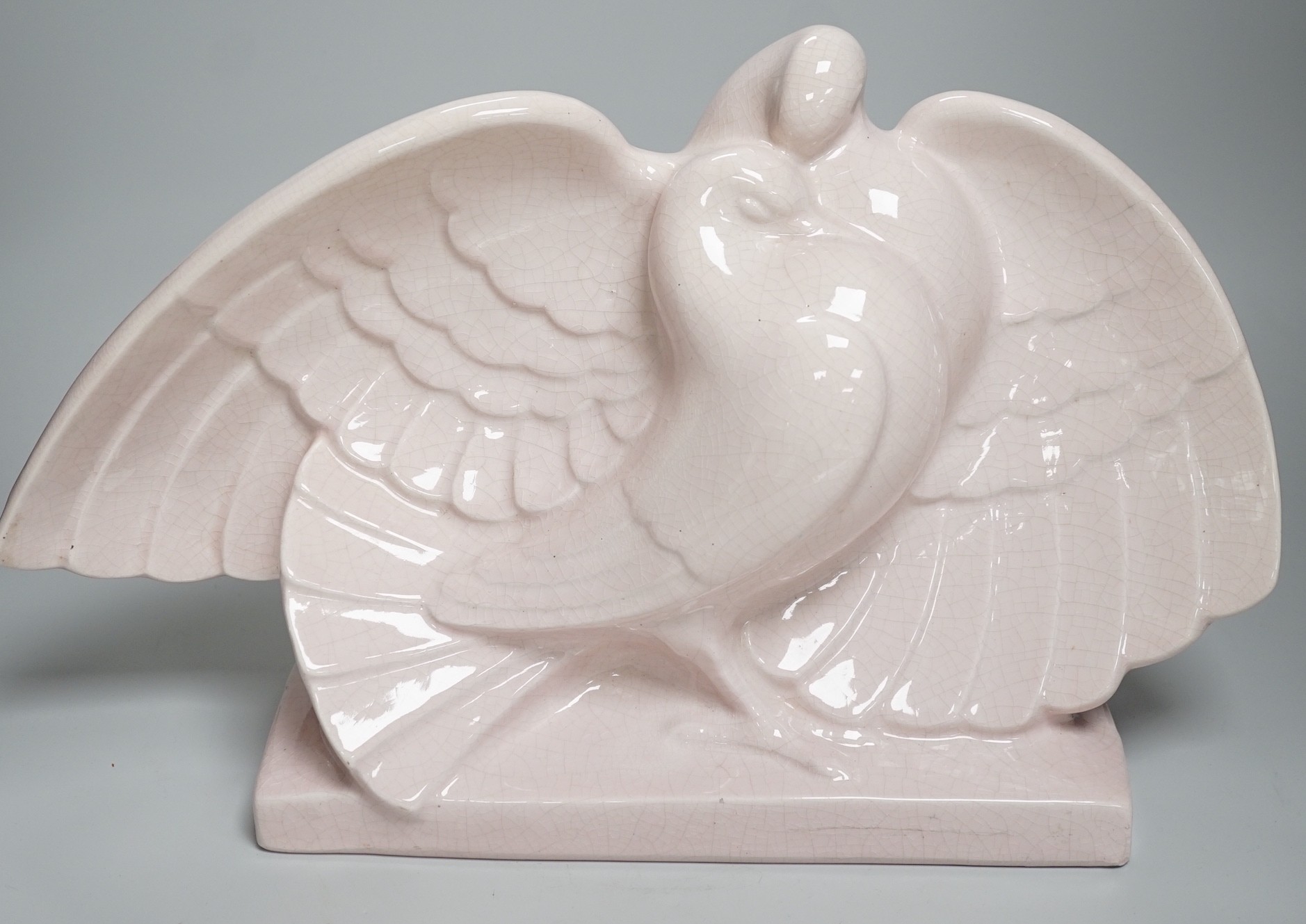 A French Art Deco Lejan pink crackleware model of a pair of doves, 26cms high x 45cms wide